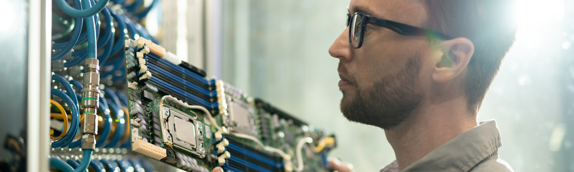 An IT Technician replacing a rack-mounted motherboard.