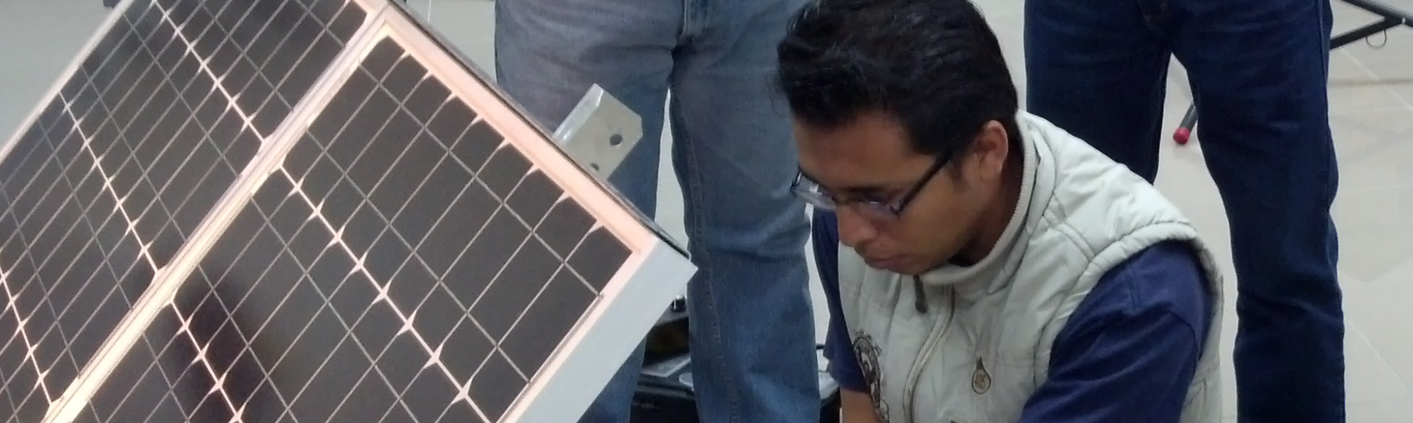 An instructor connects a GT-9500 Solar/Wind Energy Training System panel for the combined solar/wind course