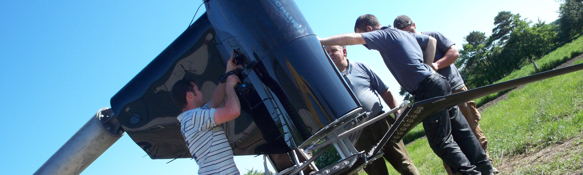 Students prepare to lift a mid-sized wind turbine upright