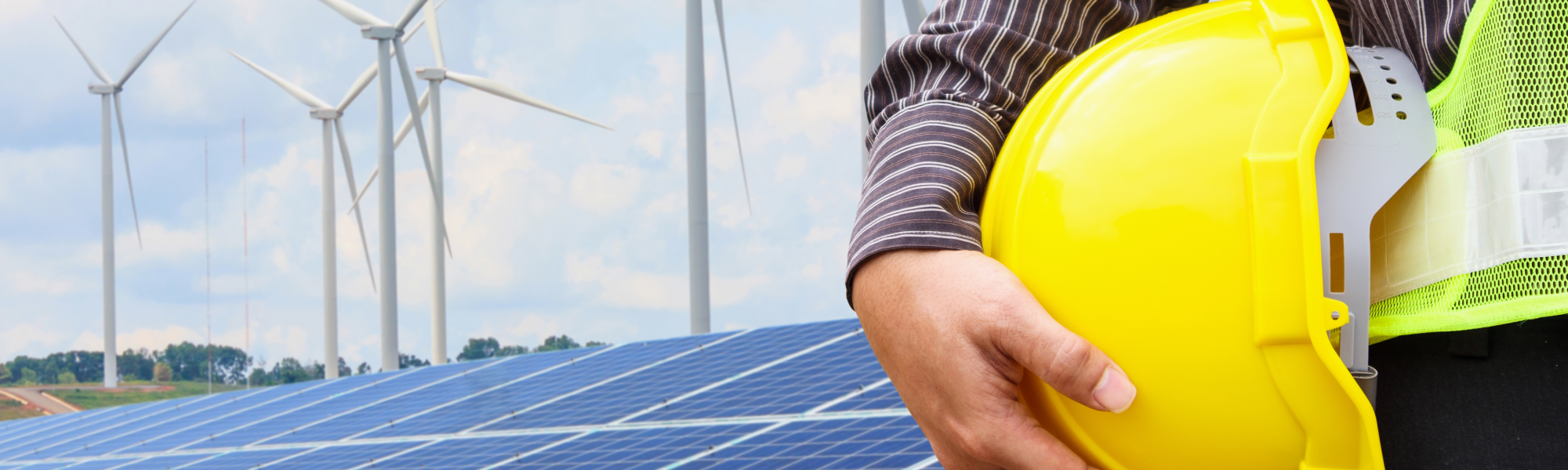 A picture of a solar panels and wind turbines