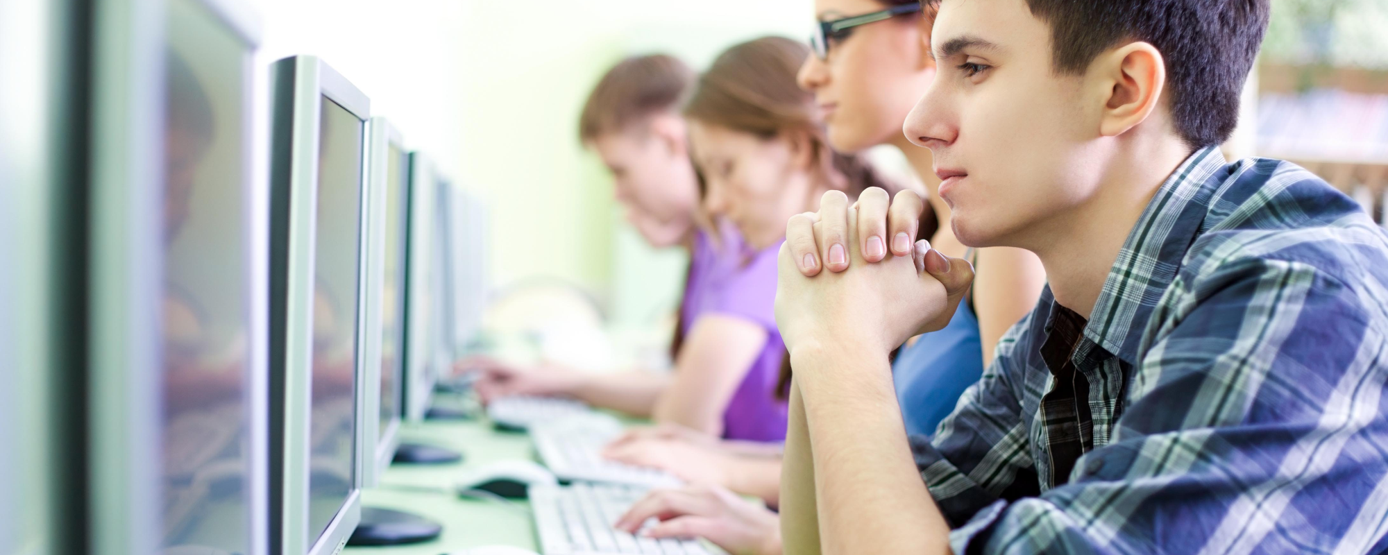 Students at computers learning about cybersecurity