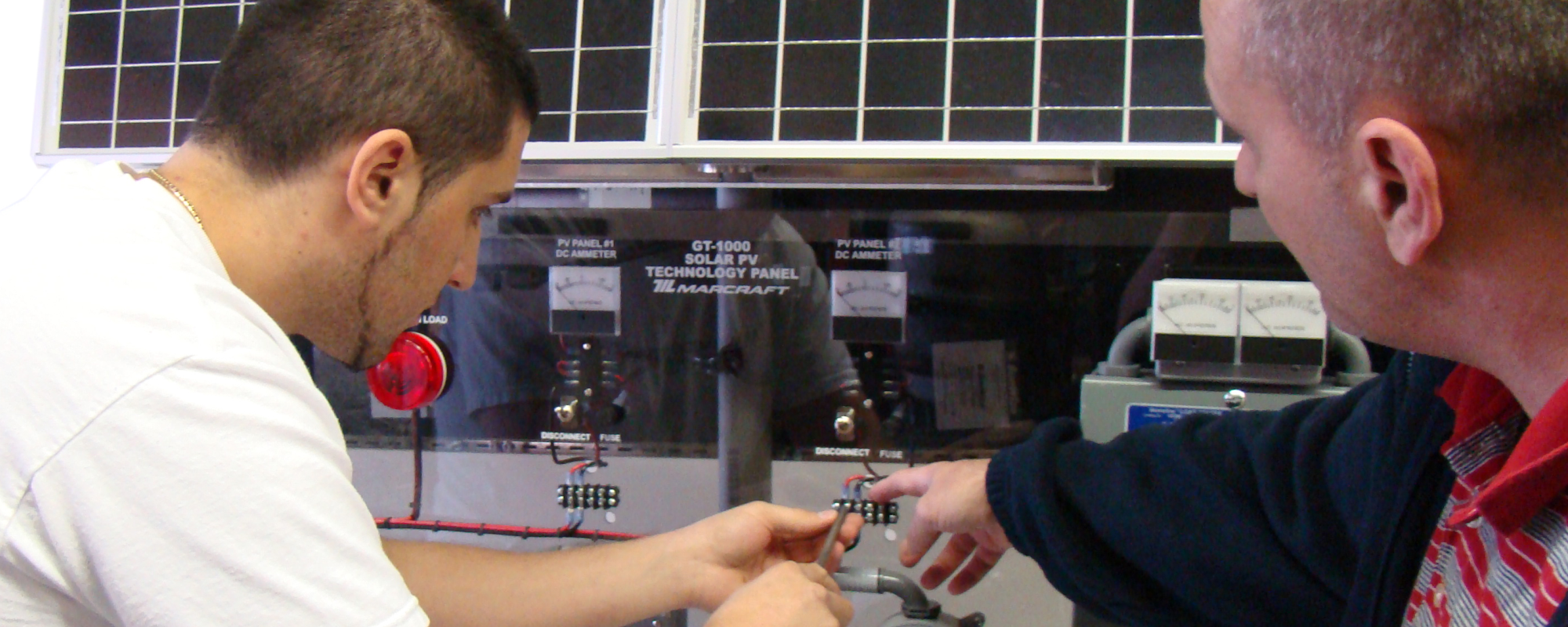 Instructor and student work on the GT-1000 Solar PV Technology Panel