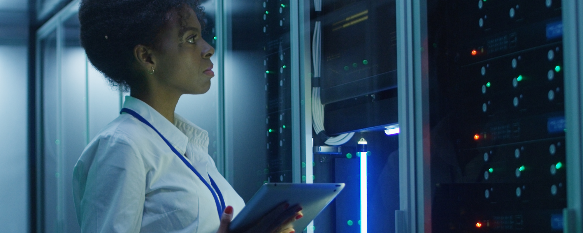 Woman in a server room as a cybersecurity analyst